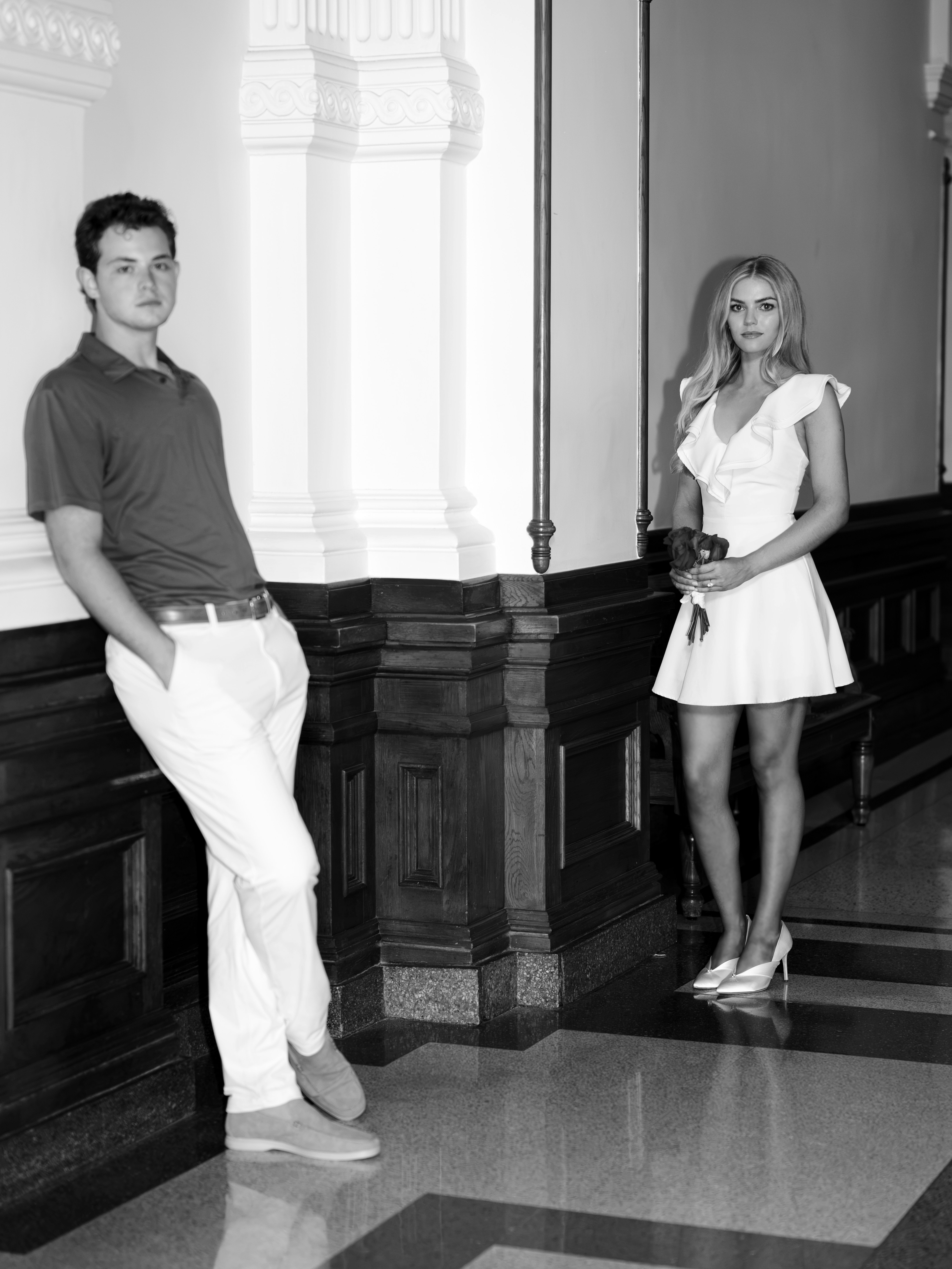 Lucy and Bridger at either end of a Capitol colonnade