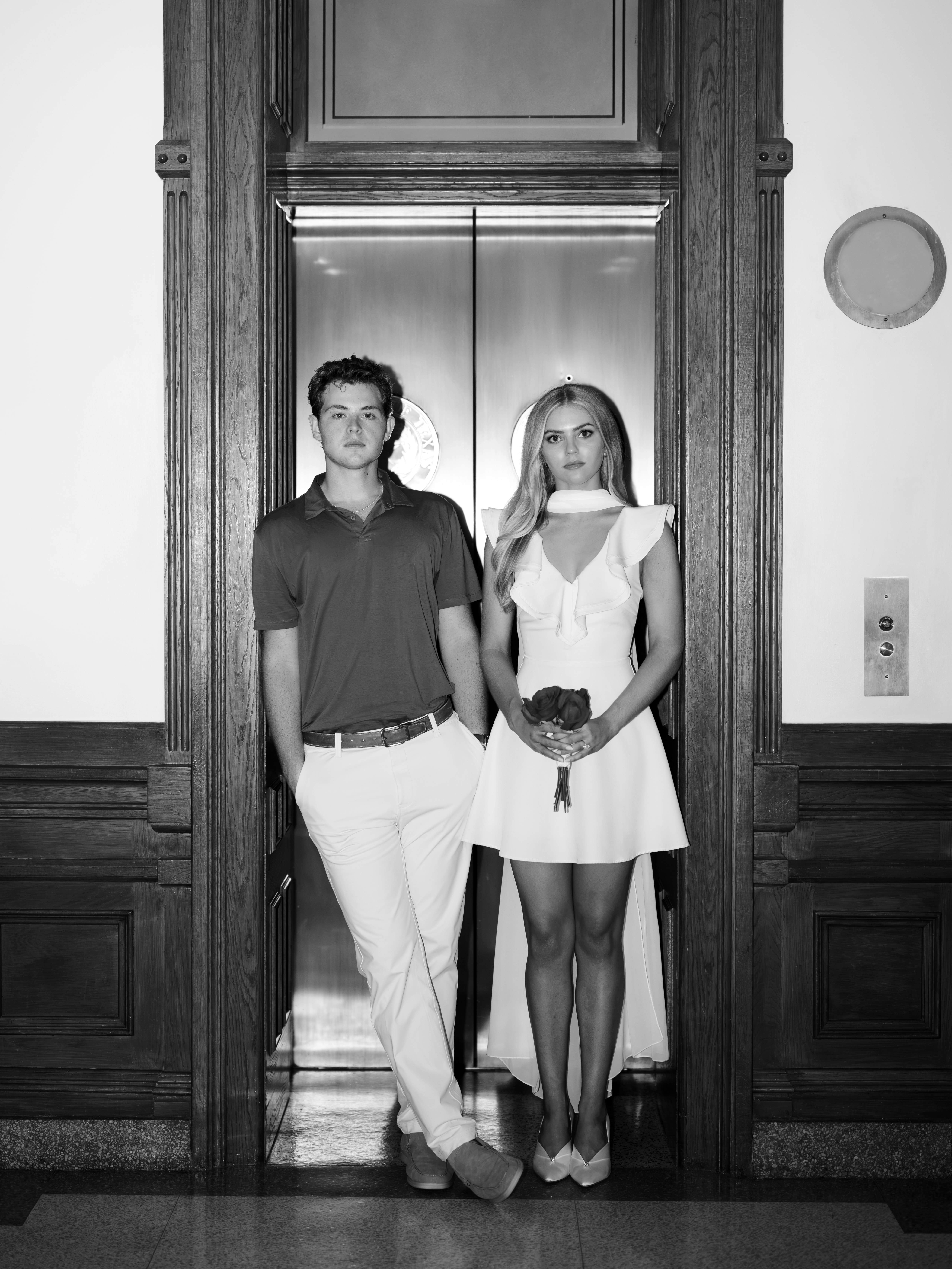 Lucy and Bridger standing together in a panelled doorway at the Texas State Capitol